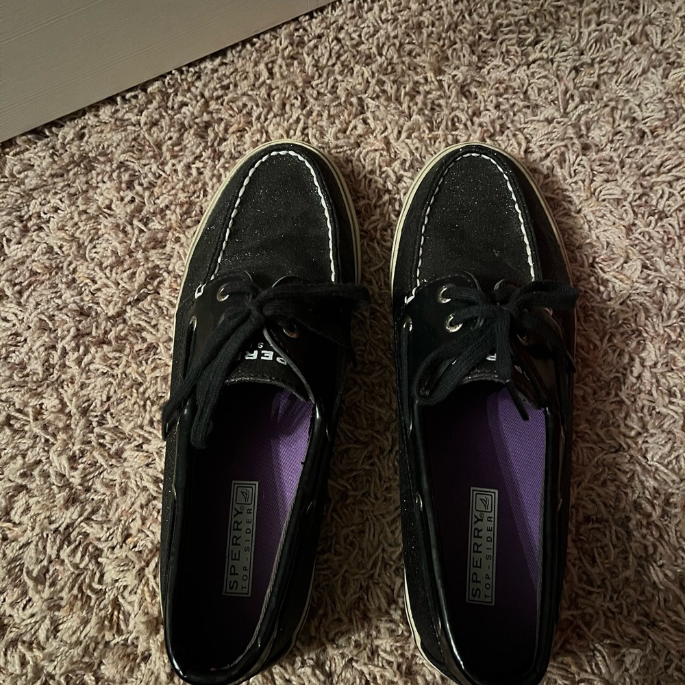 Sparkling black women’s Sperry Topsider shoes.